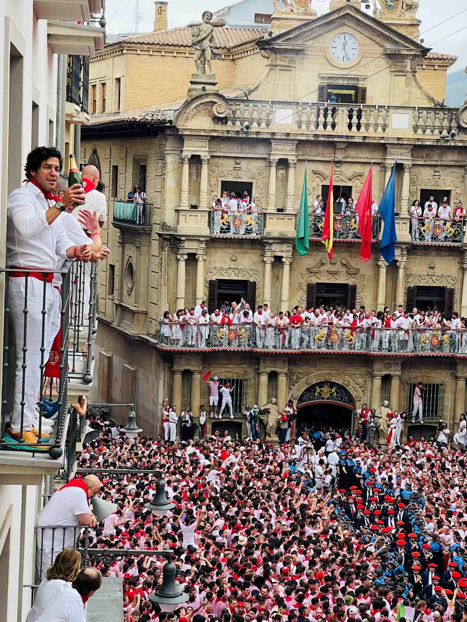San Termini Opening Ceremony with people celebrating with champagne on balcony and crowds below in Northern Spain